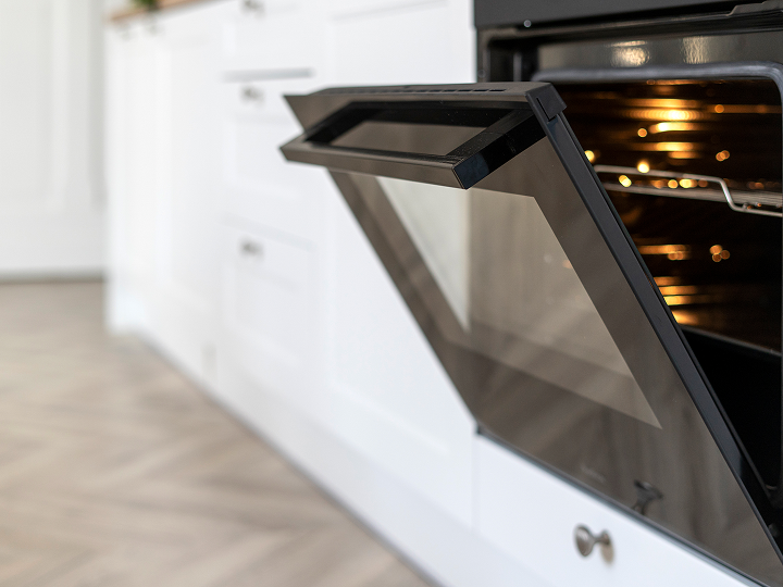 A close up of an oven door with the doors open