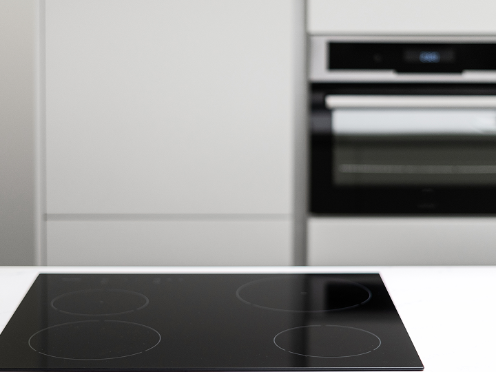A black stove top oven sitting in front of an oven.