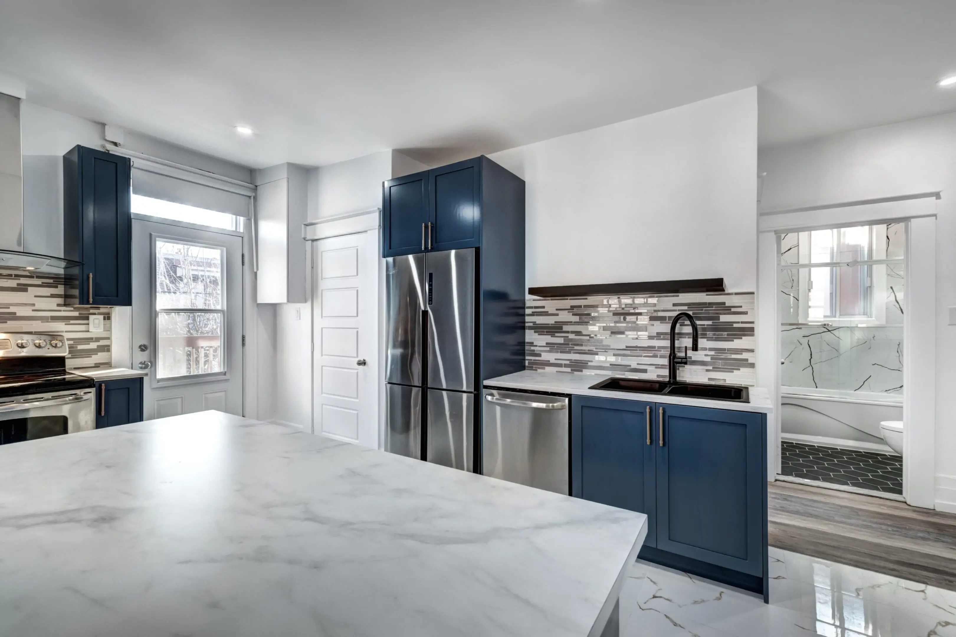 jpeg-optimizer_6835d7d263dce_Image20250527065220 A kitchen with blue cabinets and white walls