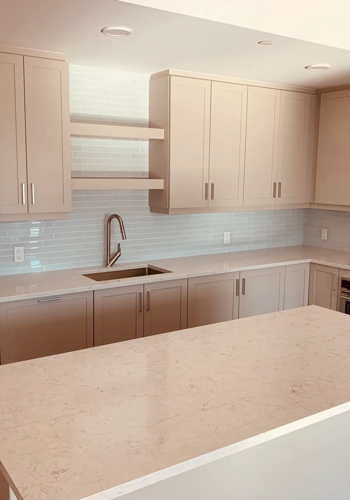 rs=w_2320,h_1740 A kitchen with white cabinets and a large island.